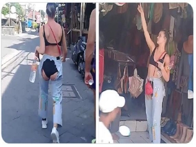 Australian tourist wearing bizarre ripped jeans that shows her underwear  on both sides  in shopping streets of Kuta.